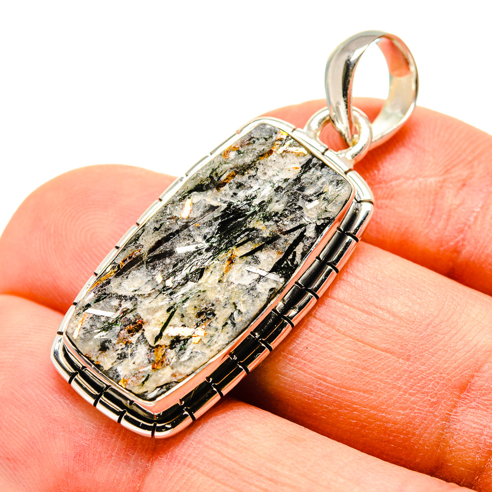 Rough astrophyllite pendant in 925 sterling silver, oval cabochon with textured stone.