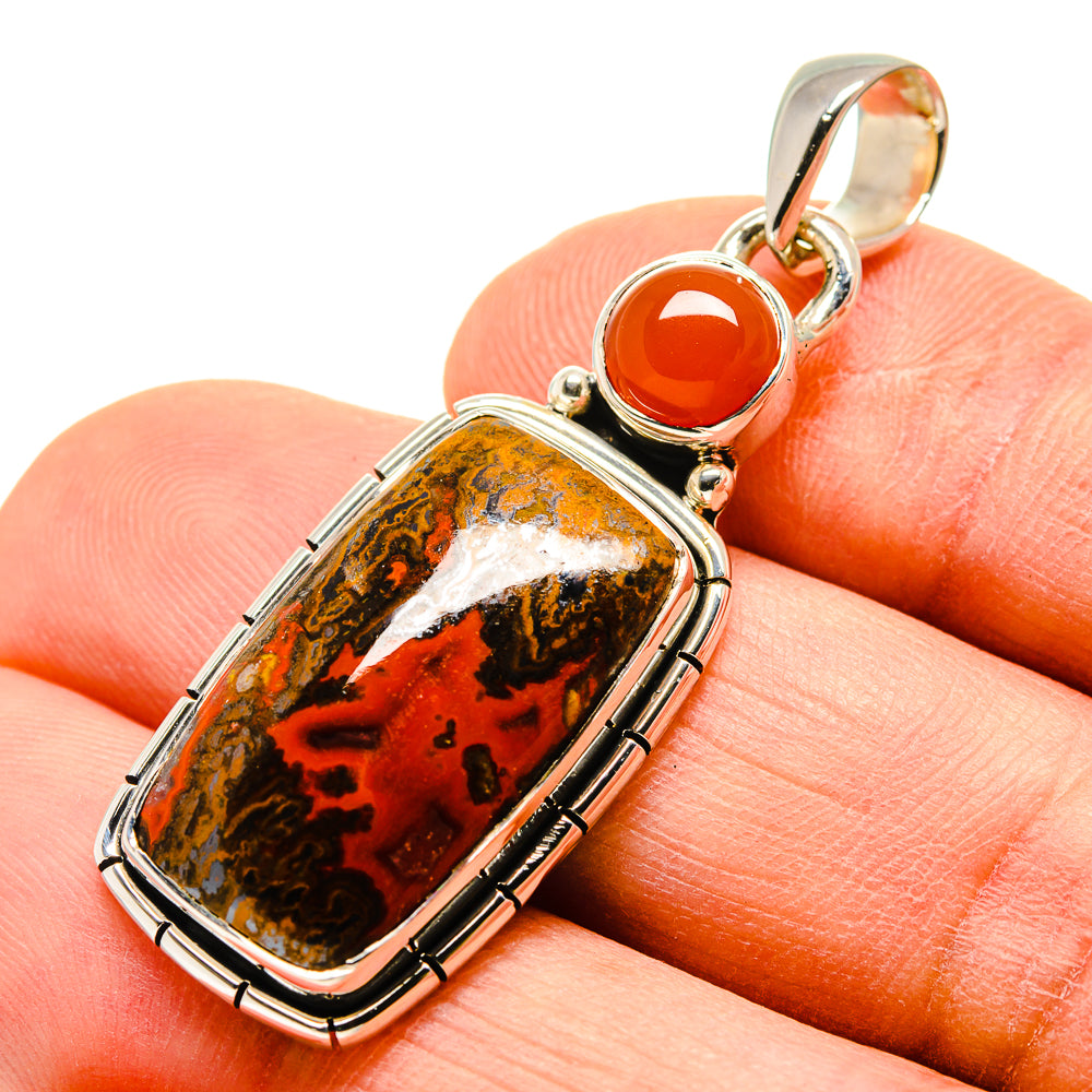 Sterling silver pendant showing rectangular red-brown agate with bezel frame and round orange stone