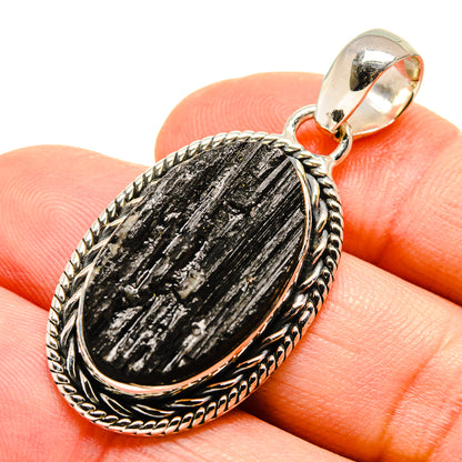 Black tourmaline pendant in oval 925 sterling silver frame with textured bail