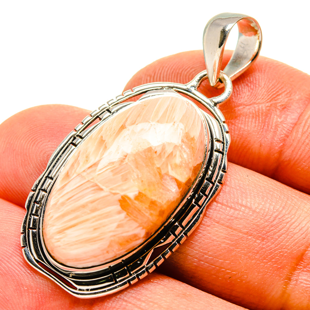 Sterling silver scolecite pendant with peach-orange oval cabochon and rope bezel