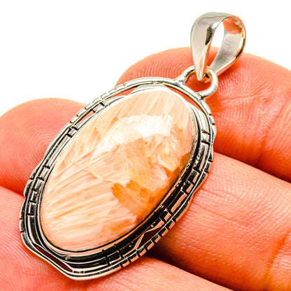 Sterling silver scolecite pendant with peach-orange oval cabochon and rope bezel
