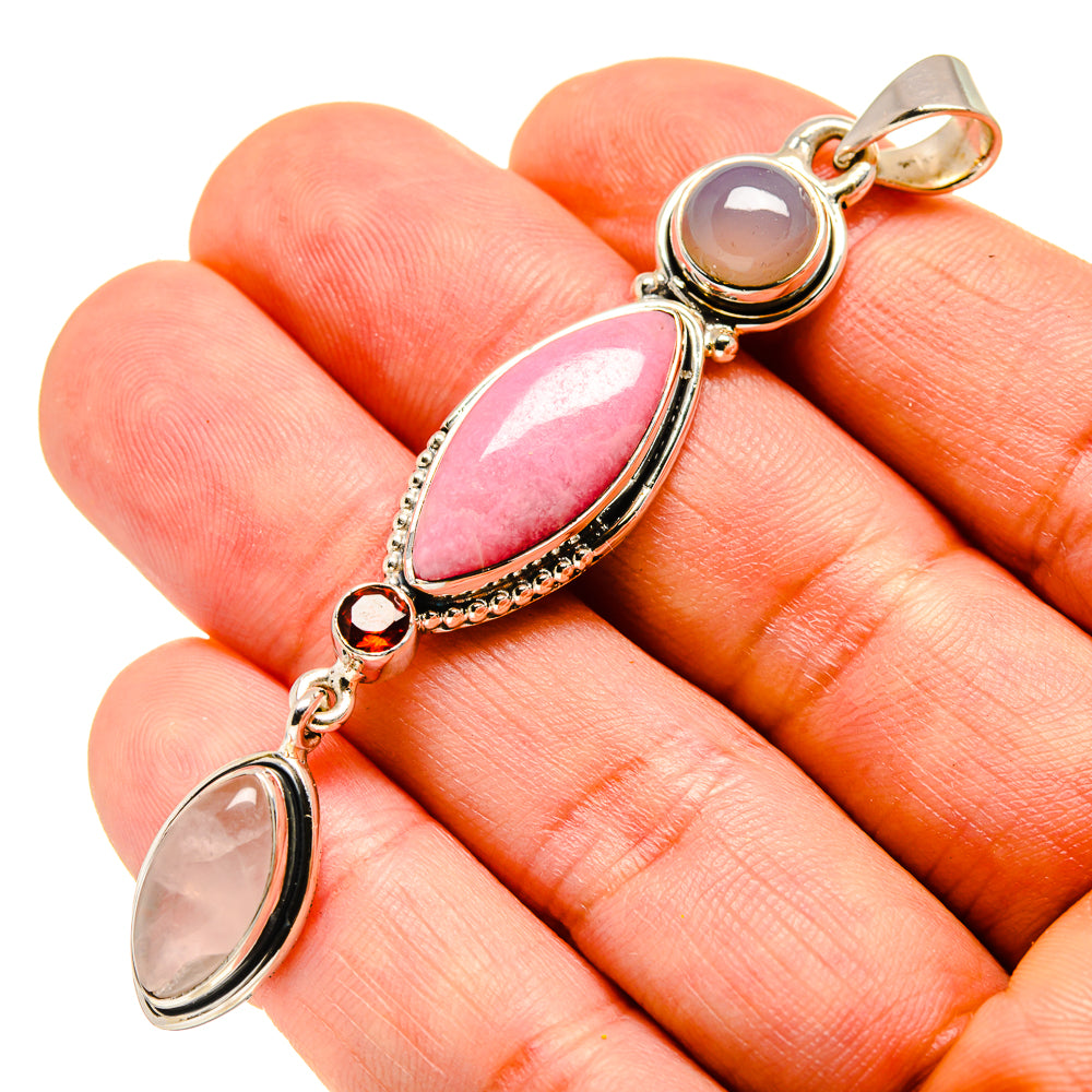 Gold-tone close-up pendant with pink oval stone and round light stone charm