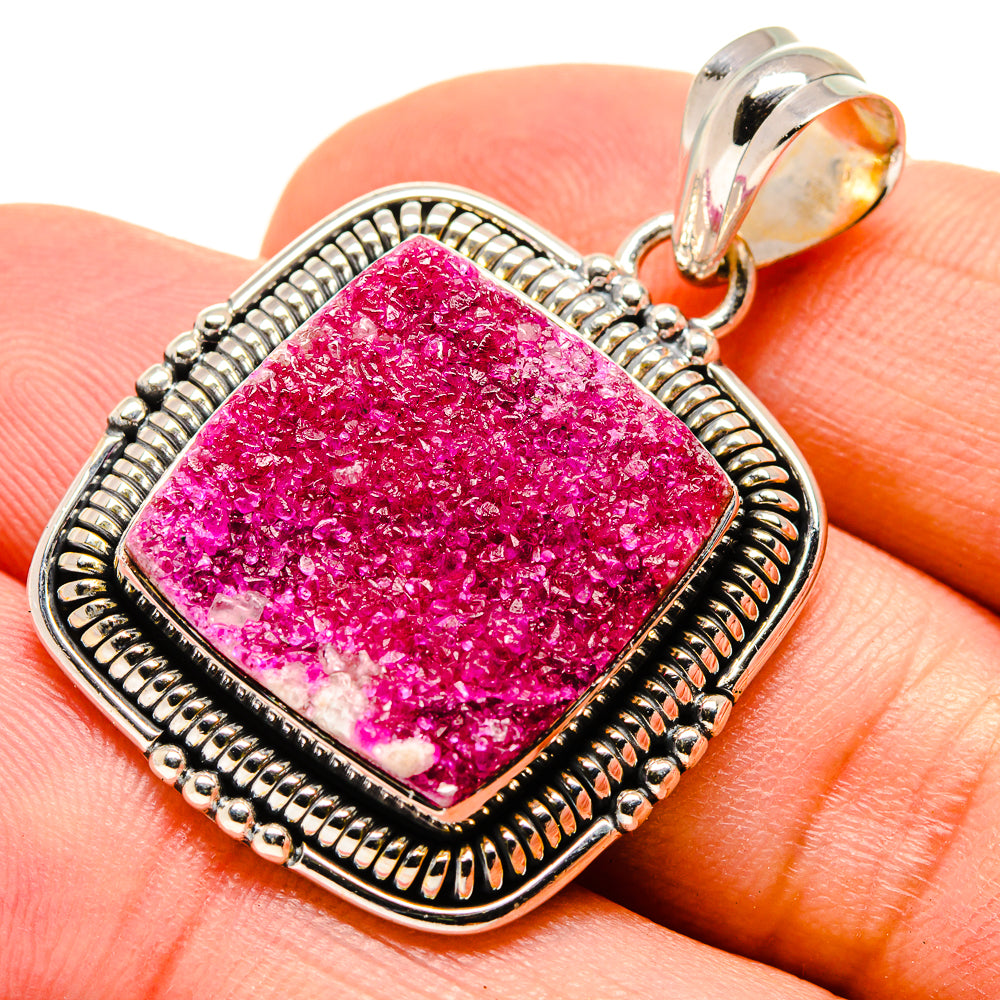 Pink druzy calcite pendant in a square sterling silver bezel with ornate rope border.