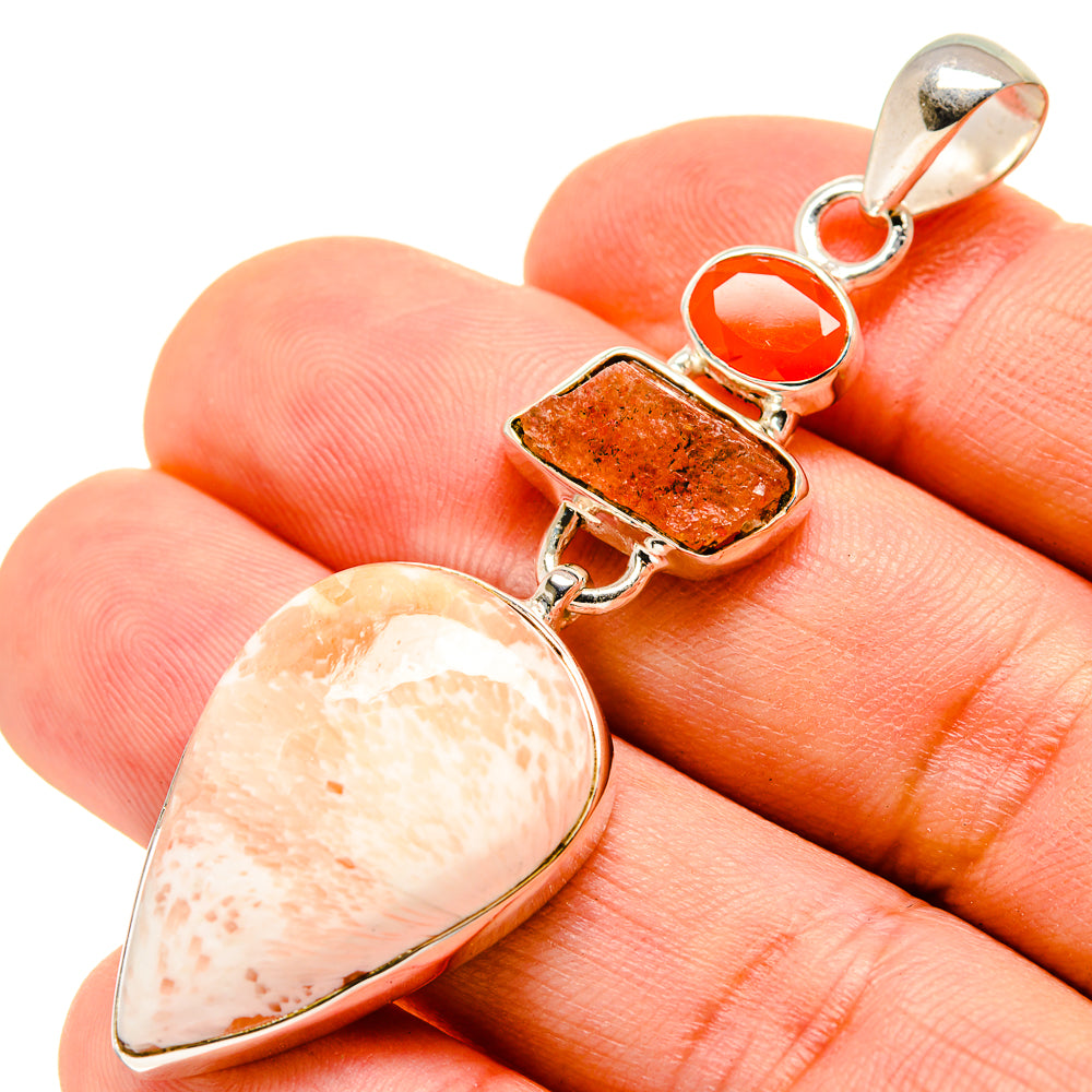 Sterling silver gemstone pendant with teardrop, rectangular, and round orange stones