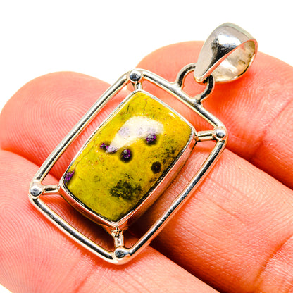 Sterling silver pendant featuring rectangular yellow stone with purple speckles, bail top