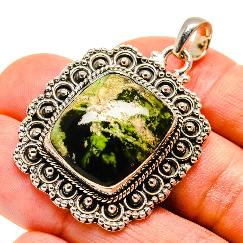 Sterling silver opal pendant close-up with green cabochon and round bail