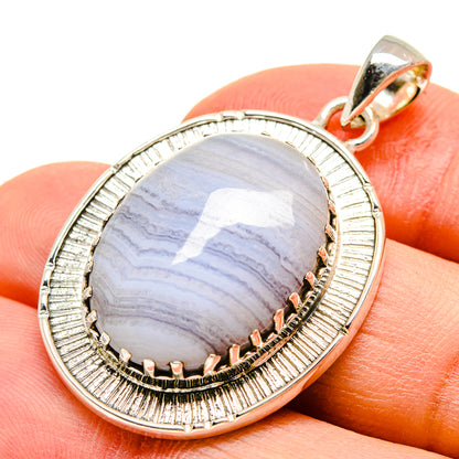 Sterling silver pendant with oval blue lace agate cabochon, scalloped ridged bezel and bail