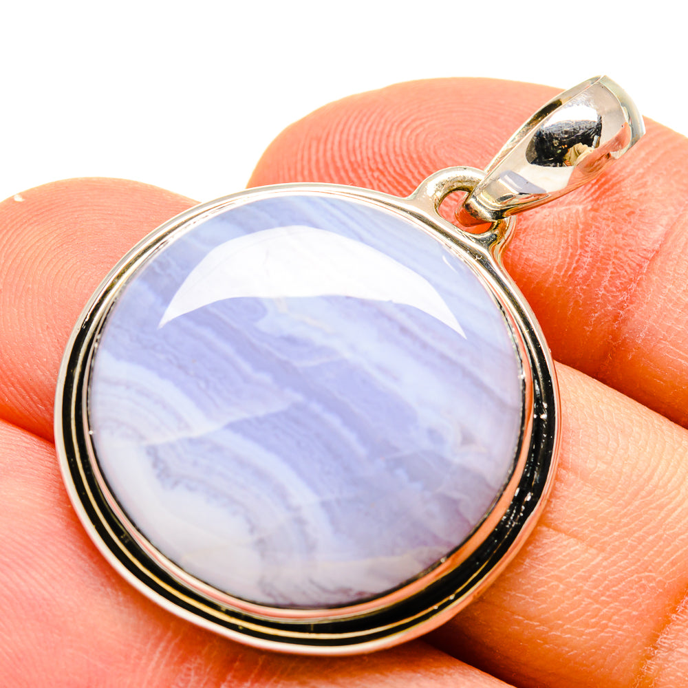 Round lace agate pendant with blue and white banded stone, silver-tone bezel.