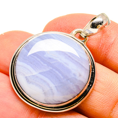 Round lace agate pendant with blue and white banded stone, silver-tone bezel.