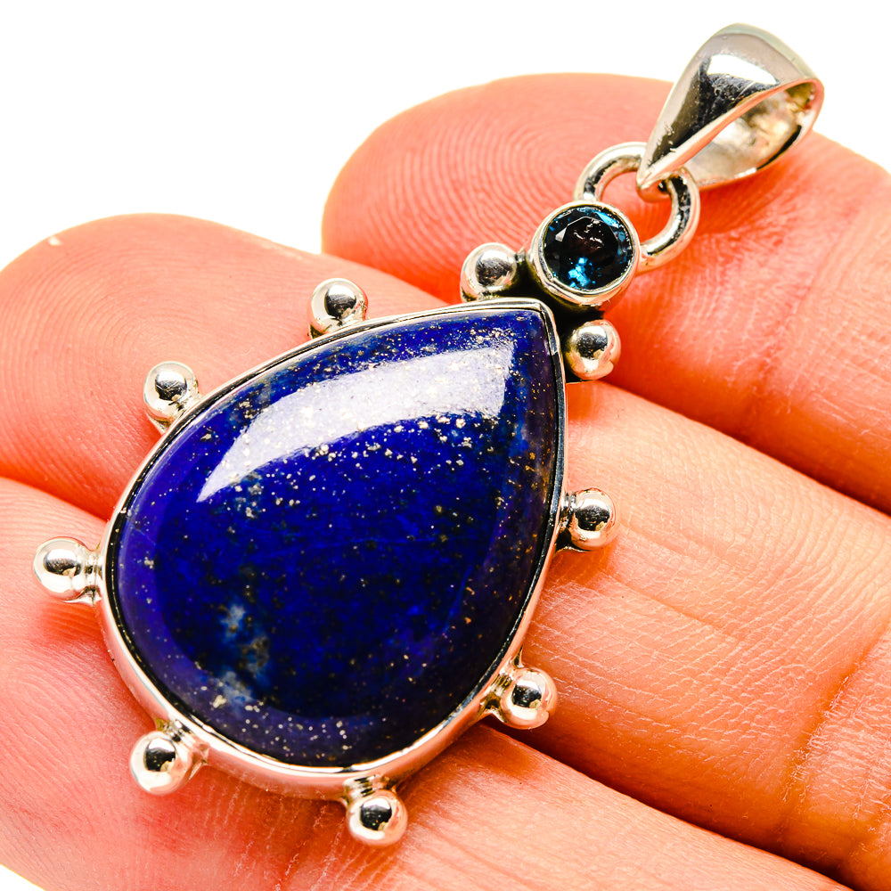 Lapis lazuli teardrop pendant with round blue topaz accents in sterling silver