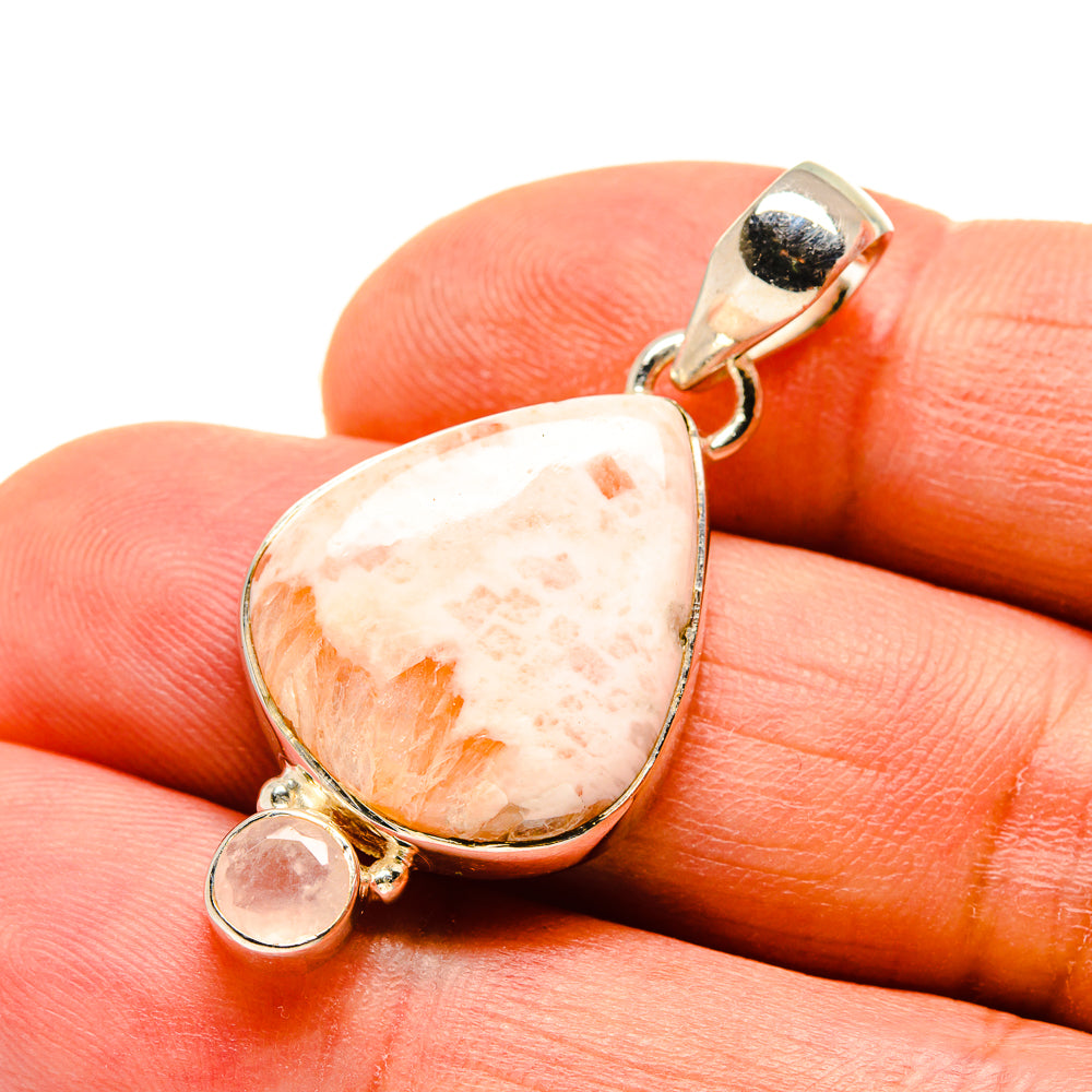 Rose quartz teardrop pendant in silver setting with small round stone detail