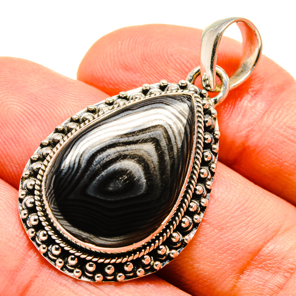 Teardrop silver pendant with black-and-gray banded stone, beaded rim, and loop bail