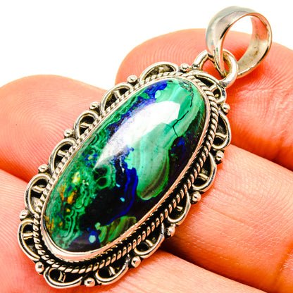 Malachite and chrysocolla oval pendant with textured silver frame and loop bail