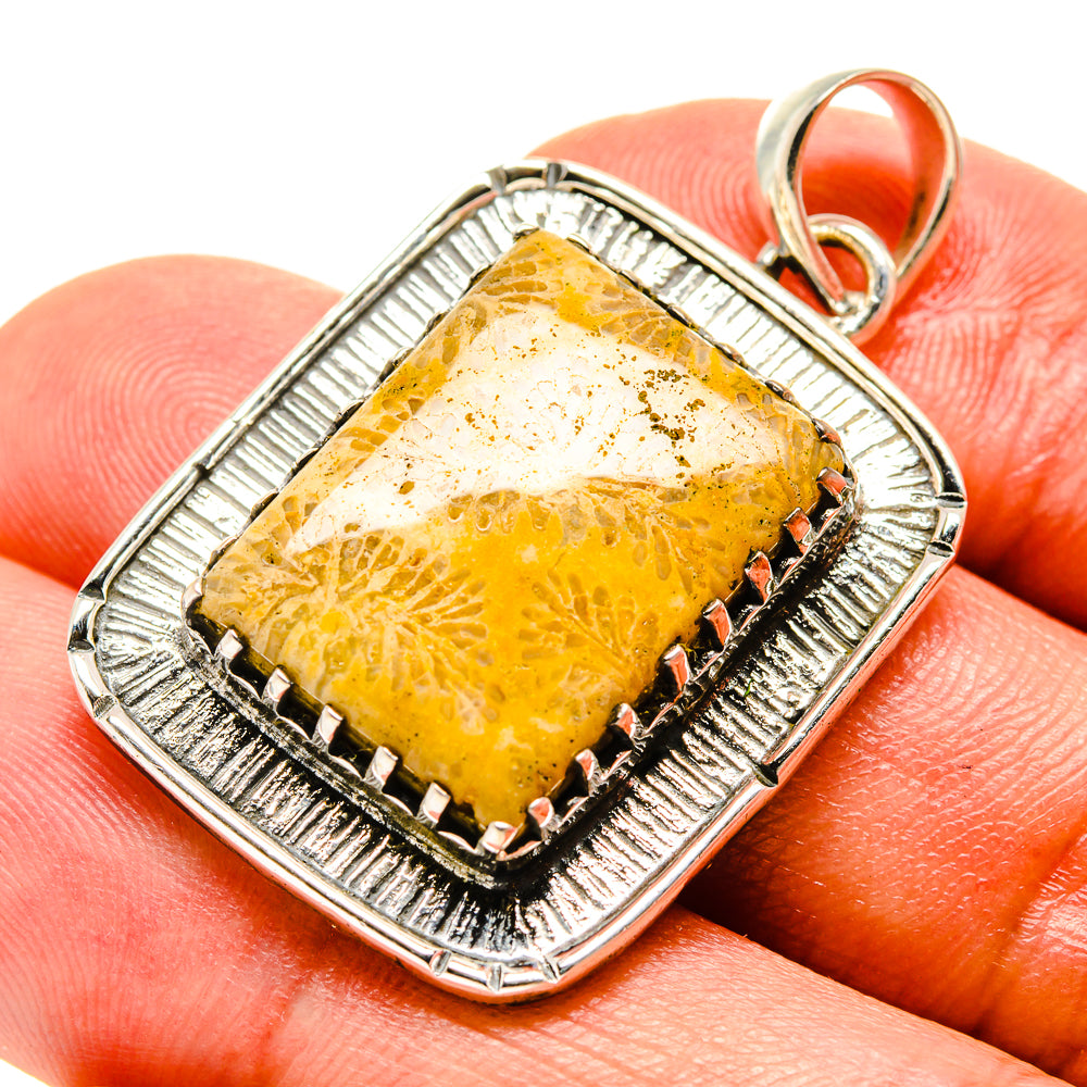 Sterling silver pendant with rectangular yellow-orange fossil coral and prong border