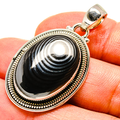 Oval psilomelane pendant with black-gray cabochon, beaded 925 silver frame