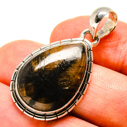 Sterling silver oval pendant with golden-brown stone and bail