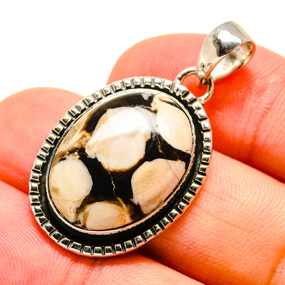 Oval jasper pendant in 925 sterling silver with textured bezel and top bail, on finger