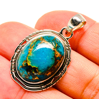 Sterling silver turquoise pendant, oval blue stone with copper matrix, on finger