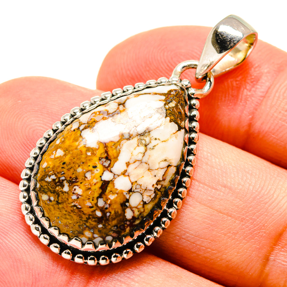 Jasper teardrop pendant with silver bezel and loop bail, shown on a finger