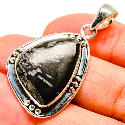 Sterling silver teardrop pendant with black and gray marbled gemstone and scalloped bezel