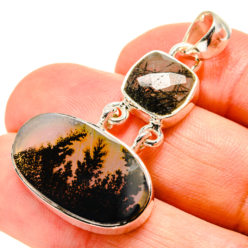 Oval gemstone pendant on bail with dendritic black pattern over gold, sterling silver