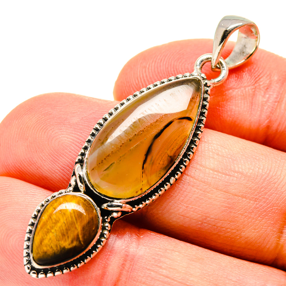 Sterling silver tiger eye pendant close-up with oval stone and small cabochon drop