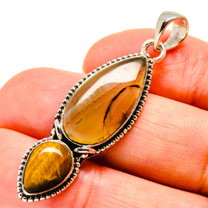 Sterling silver tiger eye pendant close-up with oval stone and small cabochon drop