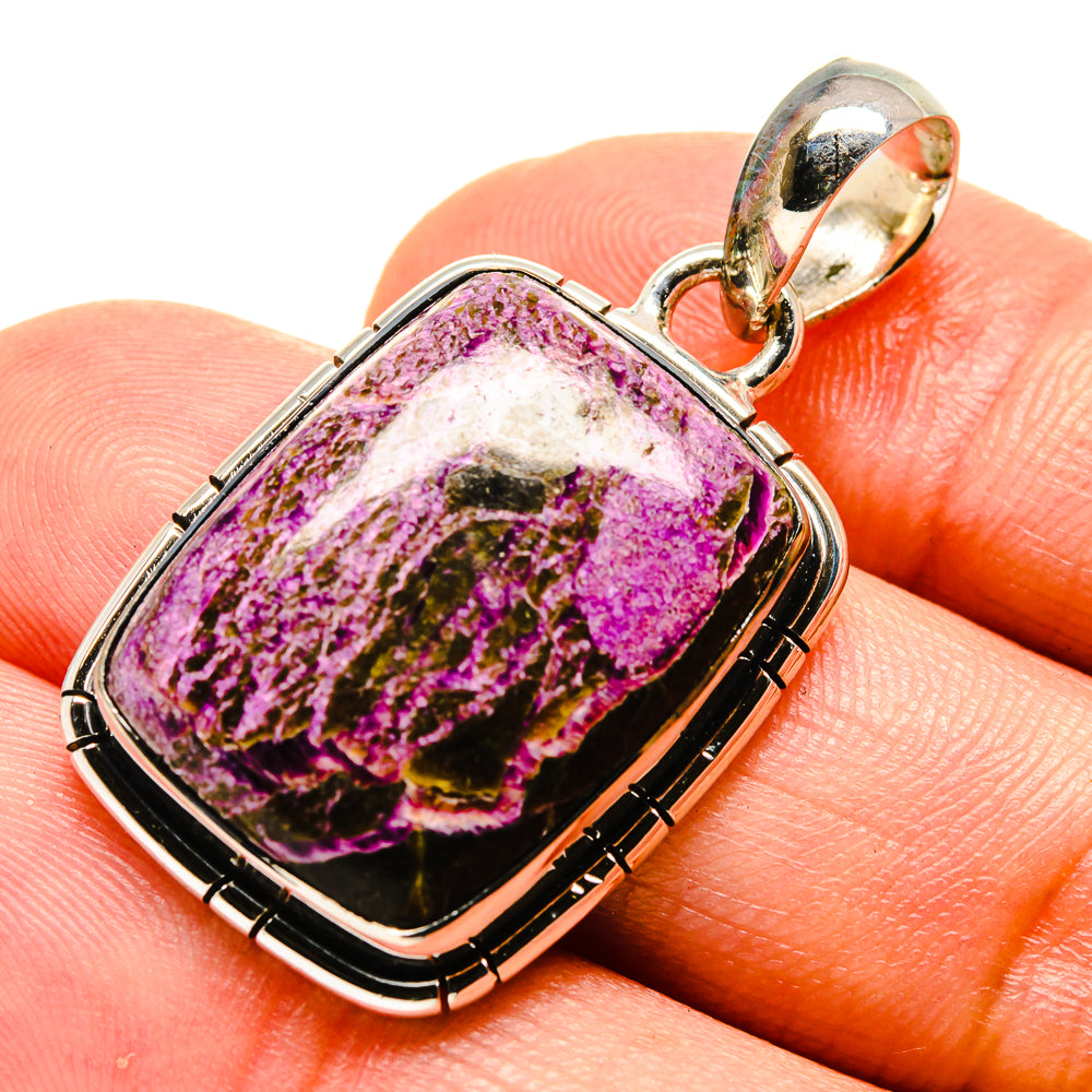 Sterling silver stichtite pendant, oval purple stone bezel on finger