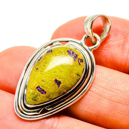Oval green-yellow gemstone pendant in silver with purple speckles and loop bail