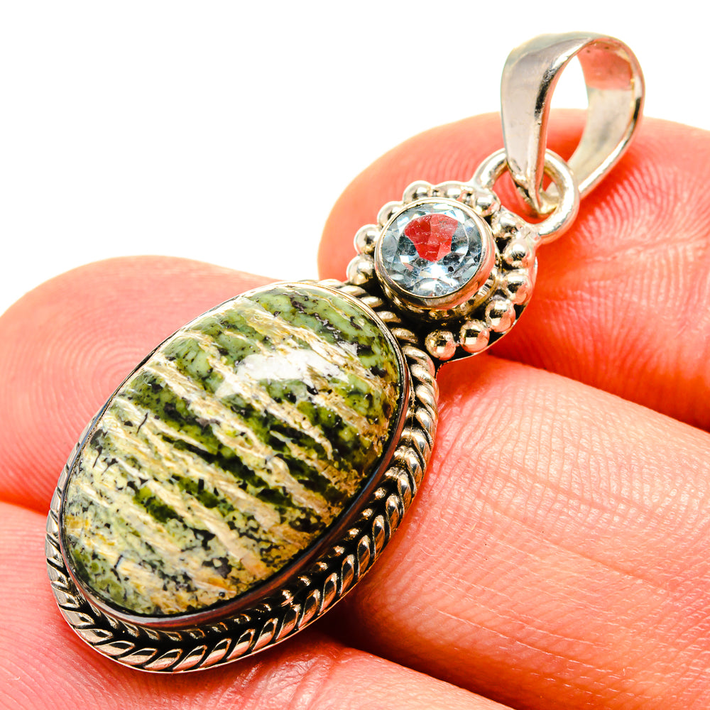 Oval lizard jasper pendant with round blue topaz accent, set in 925 sterling silver