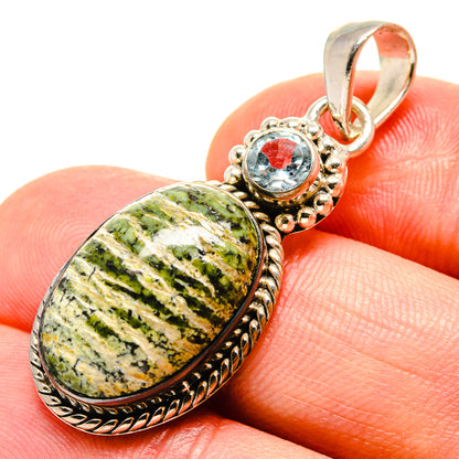 Oval lizard jasper pendant with round blue topaz accent, set in 925 sterling silver