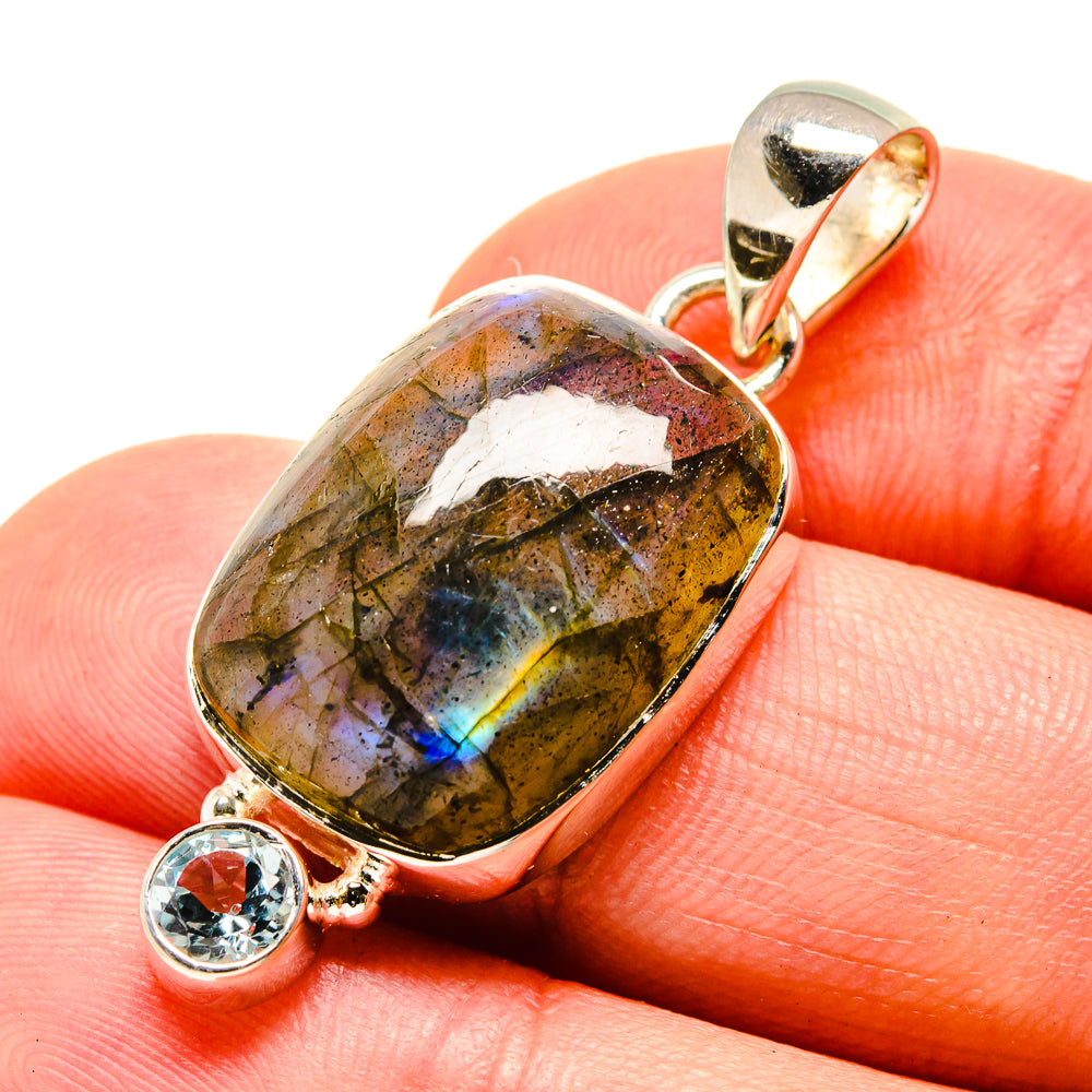 Sterling silver labradorite pendant close-up with round blue topaz accent