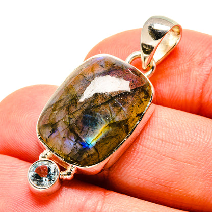 Sterling silver labradorite pendant close-up with round blue topaz accent