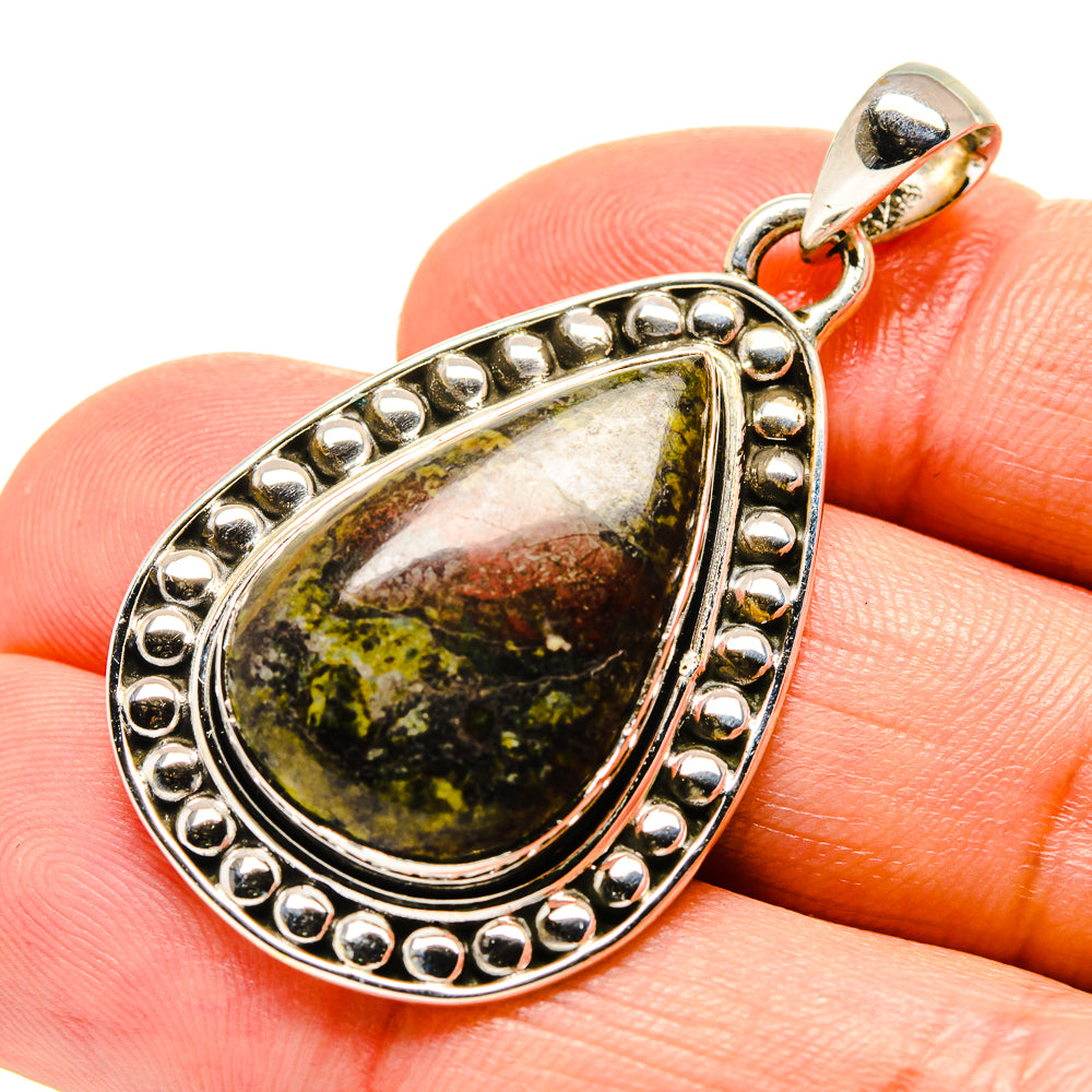 Close-up 925 sterling silver teardrop pendant with green-brown stone, beaded bezel