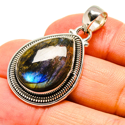 Labradorite pendant in oval sterling silver bezel with polished bail, blue-gold flash cabochon