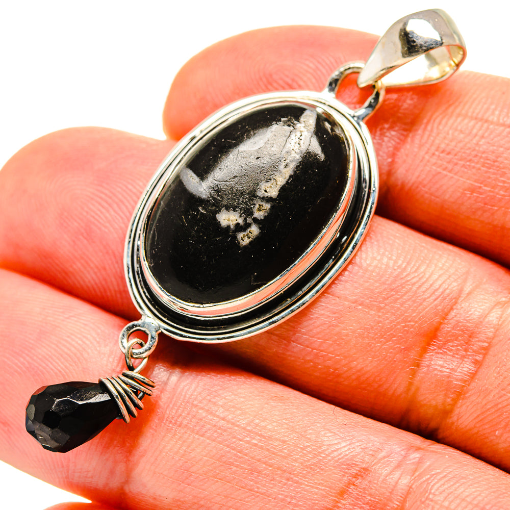 Oval onyx pendant with sterling silver bezel and small black bead, bail at top