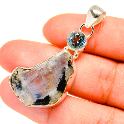 Rough moonstone pendant with round blue topaz in bezel and silver loop bail