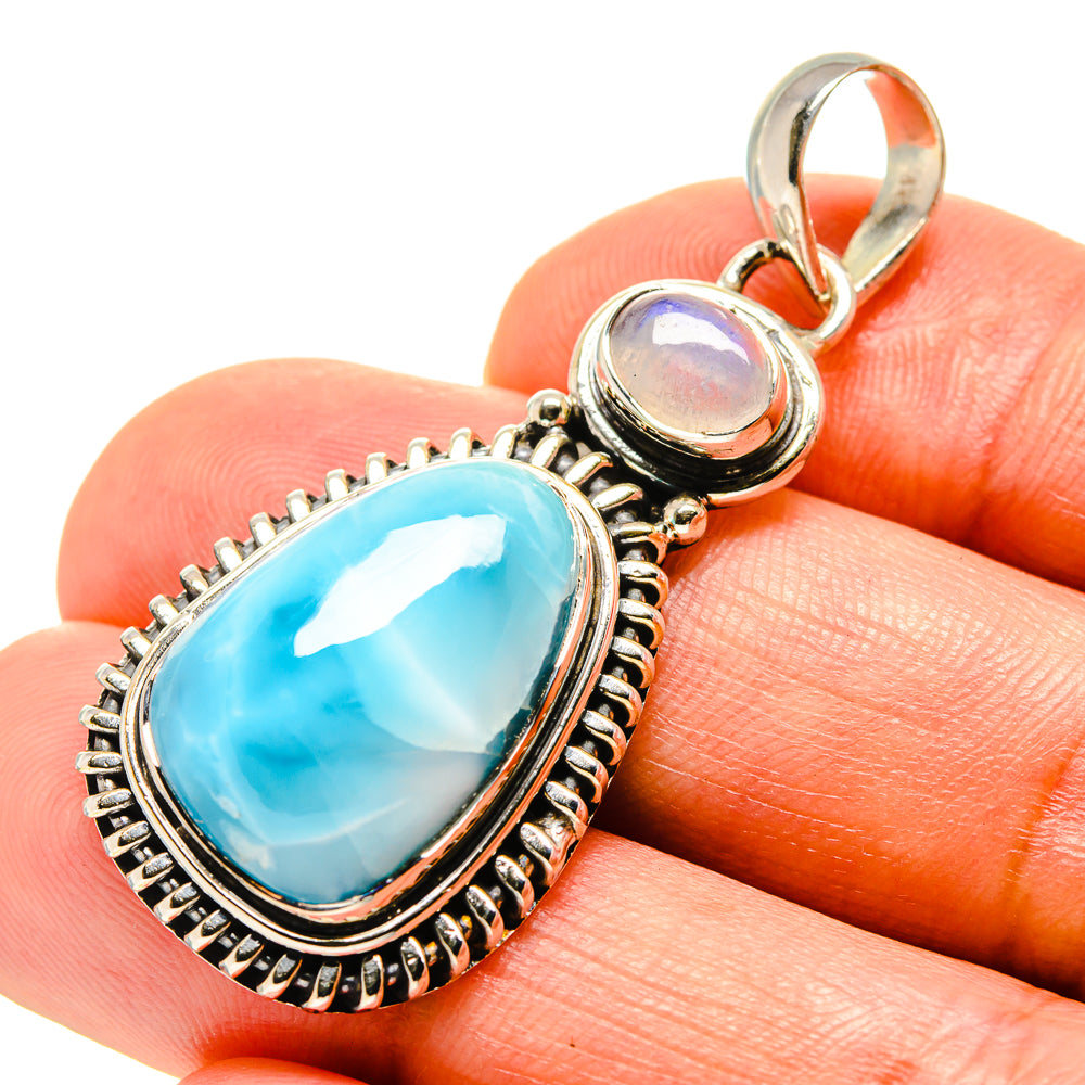 Sterling silver pendant with oval bright blue larimar stone and round opalescent accent
