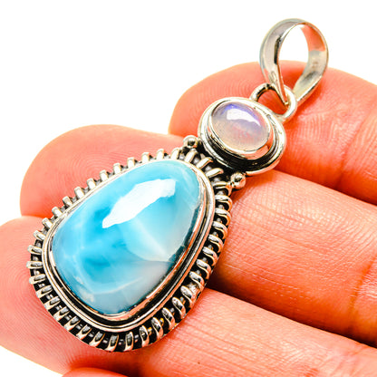 Sterling silver pendant with oval bright blue larimar stone and round opalescent accent
