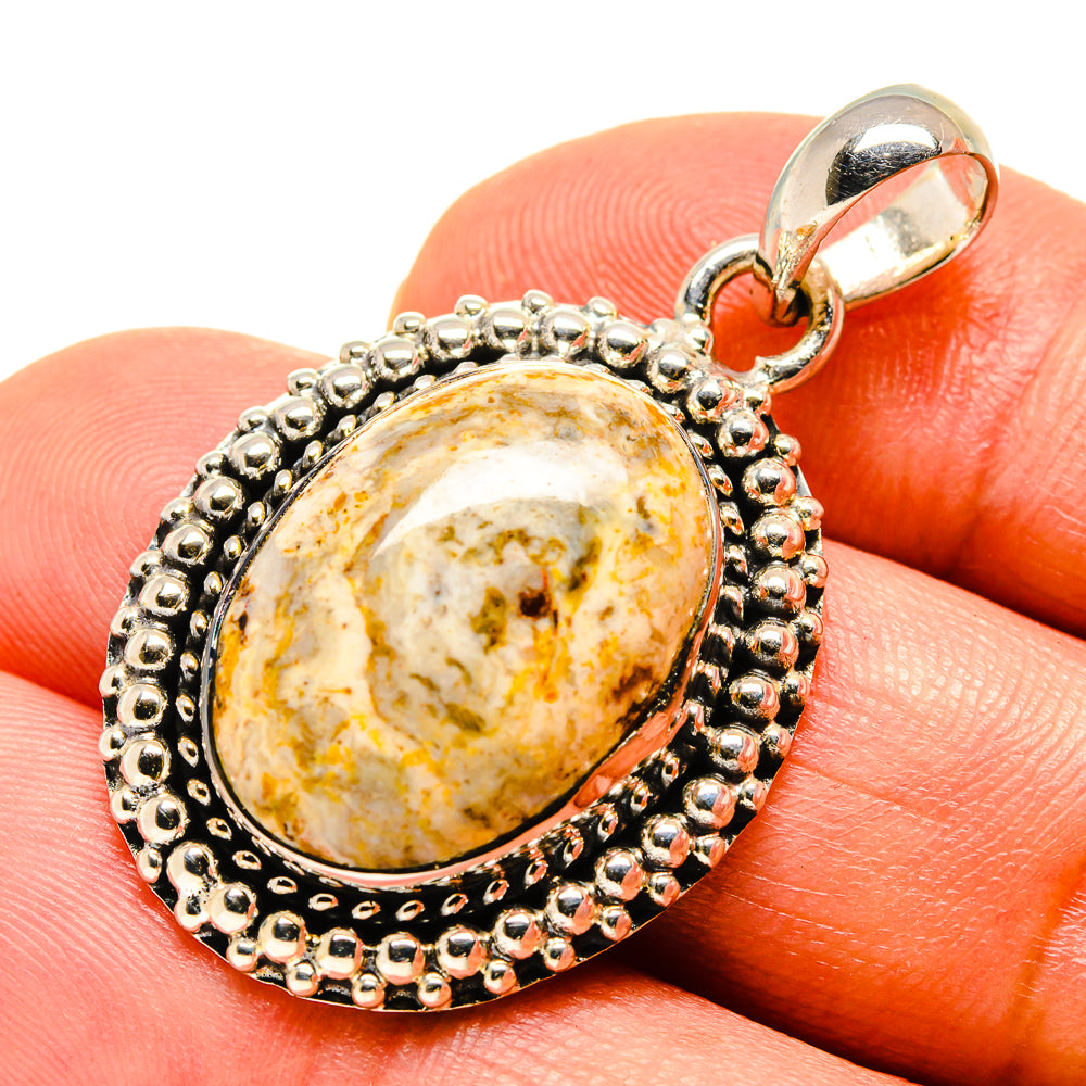 Ocean jasper teardrop pendant on finger, 925 sterling silver bezel and bail