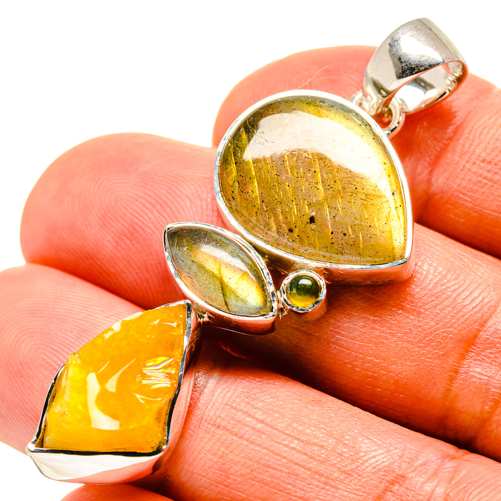 Sterling silver pendant with three opal cabochons: round yellow, oval pale blue, amber teardrop