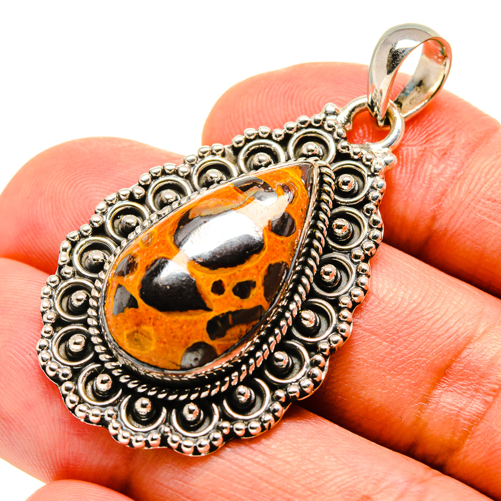 Sterling silver pendant with teardrop orange-black bauxite stone and filigree bezel
