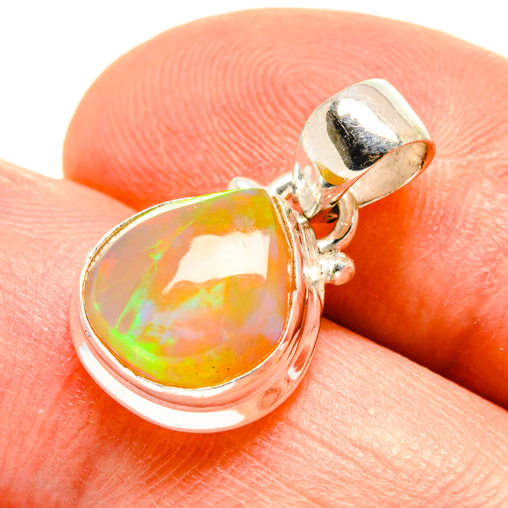 Teardrop opal pendant with orange and green color play in 925 sterling silver bezel