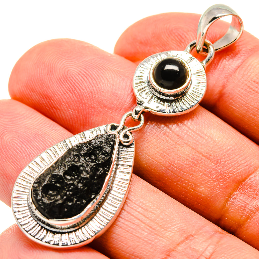 Black onyx teardrop pendant in sterling silver with textured rim and hanging bail