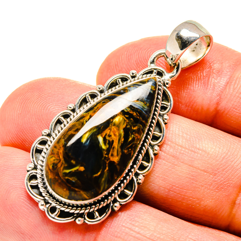 Pietersite oval pendant in silver-tone setting with ornate rope border and bail