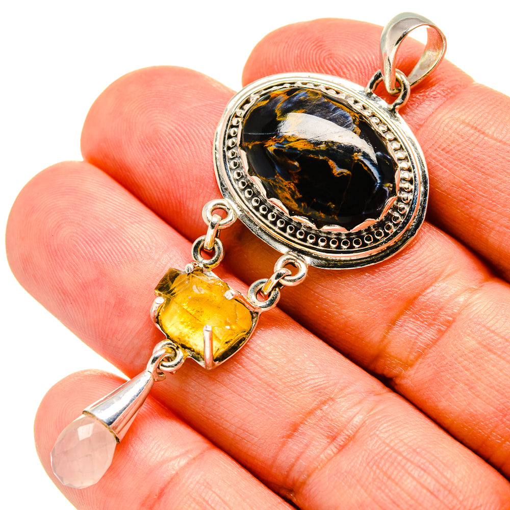 Sterling silver pendant with black oval stone, yellow citrine, and pale pink drop