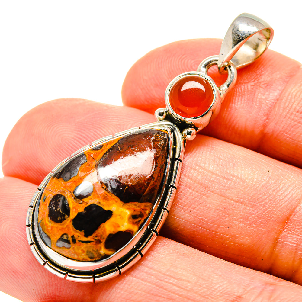 Teardrop stone pendant with orange and black speckled cabochon, gold-tone bail