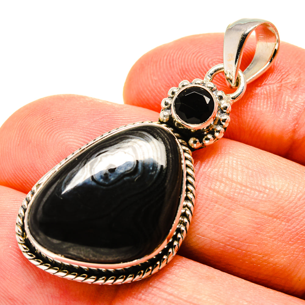 Black onyx teardrop pendant with ornate gold-tone sterling silver frame and bail