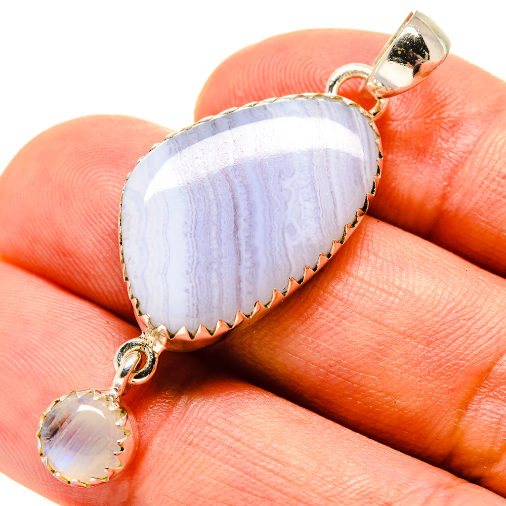 Light blue teardrop agate pendant with round accent stone in silver setting