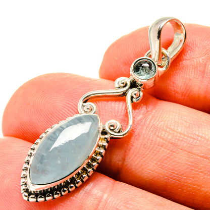 Sterling silver aquamarine teardrop pendant with oval center stone and round blue accent